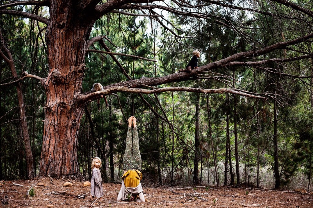 A person standing next to a tree

Description automatically generated